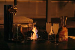a group of wine glasses on a table with a fire at Paysage 伊豆高原 in Ito