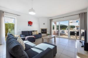 a living room with a couch and a living room with a patio at Supreme Lodge in Burgau