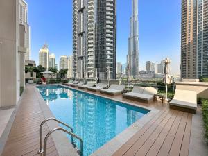 a swimming pool on the roof of a building at Luxury 2 Bedroom Apartment - Next to Dubai Opera in Dubai