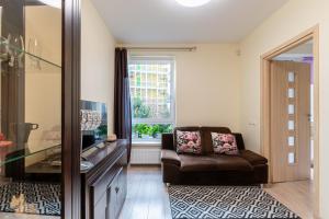 a living room with a chair and a window at Ozo park apartments in Vilnius