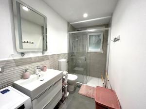a bathroom with a sink and a shower and a toilet at Apartment Diva in Zambratija +15 photos
