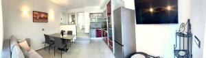 a kitchen and a dining room with a table at Apartment Diva in Zambratija