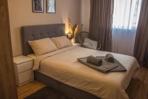 Ένα ή περισσότερα κρεβάτια σε δωμάτιο στο EVIAS Apartment