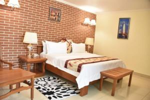 Postel nebo postele na pokoji v ubytování Grand Hôtel Aéroport, Douala
