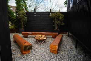 a backyard with benches and a fire pit and stairs at Cherry Tree Lodge in Limavady