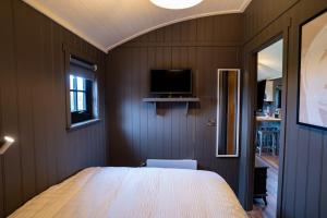 a bedroom with a large bed and a tv at Cherry Tree Lodge in Limavady +44 photos