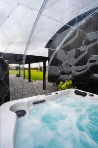 a jacuzzi tub under a tent with at Cherry Tree Lodge in Limavady
