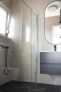 a bathroom with a glass shower and a sink at VILLA MARIS SMRIKA -heated pool in Šmrika +15 photos