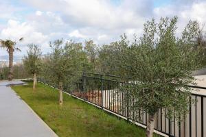 a black fence with trees in a yard at VILLA MARIS SMRIKA -heated pool in Šmrika