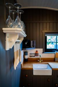 a kitchen with a sink and a counter with utensils at Cherry Tree Lodge in Limavady