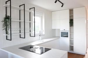 a kitchen with white cabinets and a white counter top at VILLA MARIS SMRIKA in Šmrika