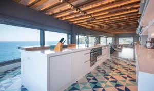 a kitchen with a counter and a floor of tiles at BYPILLOW Cap Sa Sal in Begur