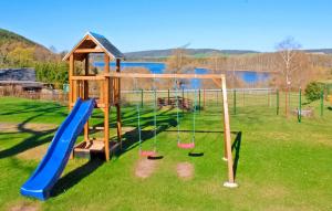 a playground with a slide and a swing set at 2 Bedroom Beautiful Apartment In Neuhausen in Neuhausen