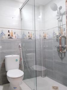 uma casa de banho com um WC e uma cabina de duche em vidro. em DIAAFATE TANNIRTE em Khenifra