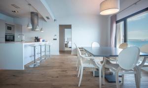 a kitchen and dining room with a table and chairs at BYPILLOW Cap Sa Sal in Begur