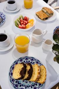 a table topped with plates of food and fruit at Nevma Suites in Firostefani
