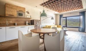 a kitchen and living room with a table and chairs at BYPILLOW Cap Sa Sal in Begur