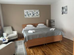 a bedroom with a bed with two towels on it at Apartments Manila in Zagreb