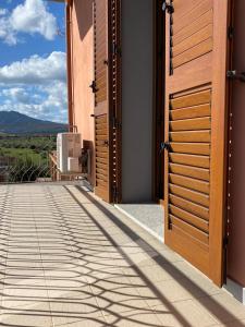 a pair of doors on a building with a view at Tequila Rooms in Olbia