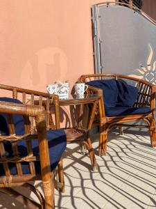 オルビアにあるB&B Tequilaの籐の椅子2脚、ガラスのテーブルと椅子