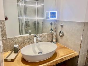 a bathroom with a white sink and a shower at Strandhotel 21 in Laboe