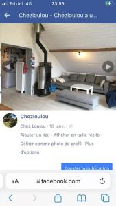 a screenshot of a room with a couch and a fireplace at Appartement chez Loulou in Léon