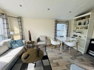 ein Wohnzimmer mit einem Sofa und einem Tisch in der Unterkunft Beach Resort Nieuwvliet-Bad 1240 - EEZZ in Nieuwvliet