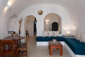 a living room with a bed and a table at Nevma Suites in Firostefani