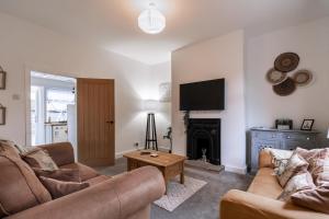 a living room with two couches and a fireplace at Railway Retreat in Wakefield