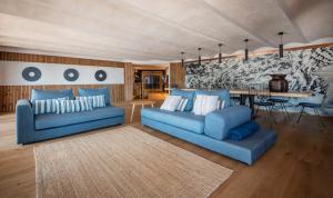 a living room with two blue couches and a table at BYPILLOW Cap Sa Sal in Begur