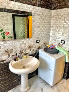 a bathroom with a sink and a mirror at شقة جديدة بالكامل in Port Said