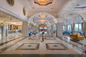 a lobby of a hotel with couches and chairs at Rodos Palladium Leisure & Wellness in Faliraki