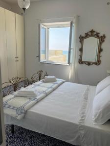 a bed in a bedroom with a window at Villa sul mare Salerno in Pontecagnano