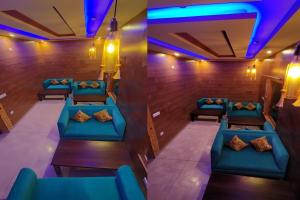 a row of blue chairs in a room with purple lights at Satine Resort Auli in Joshīmath