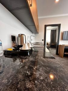 a living room with a black marble floor at VPLUS HOTEL in Istanbul