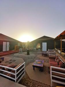 a living room with a large tent with the sun setting at The Friendly Camp in Zagora