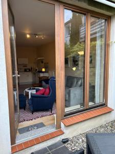 a sliding glass door of a room with a living room at Körner Nr 1 - ABC27 in Wismar