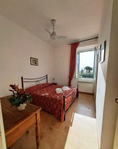 a bedroom with a bed and a window at Agriturismo Podere Novo in Lido Di Fondi