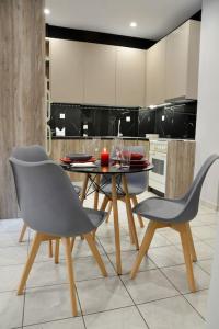 a kitchen with a table and chairs in a kitchen at Dream apartment in Kallithea in Athens