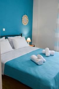 a blue bedroom with a bed with towels on it at Dream apartment in Kallithea in Athens