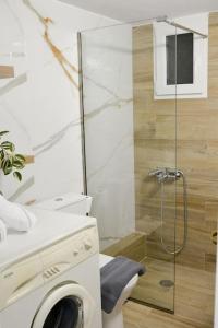 a bathroom with a shower and a washing machine at Dream apartment in Kallithea in Athens