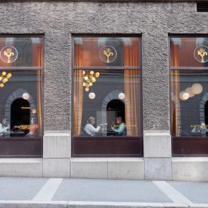 a group of people sitting in a store window at Hotell Bondeheimen in Oslo