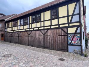 a brown and white building with a garage at Warener Hof Apartments in Waren