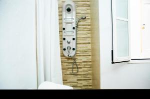 a bathroom with a shower in a brick wall at Famara Surf in Famara +30 photos