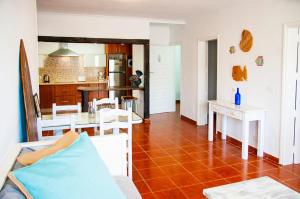a living room with a table and a kitchen at Famara Surf in Famara