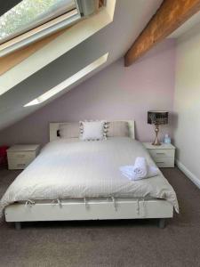 a bedroom with a bed in a attic at Contemporary Duplex: Private Patio, Secure Parking in Stockport