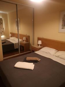 a hotel room with two beds and a mirror at Vau Costa Apartment in Portimão