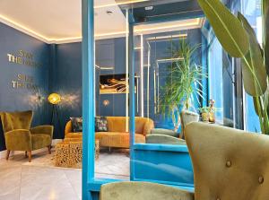 a lobby with blue walls and yellow chairs at NOX Hyde Park in London