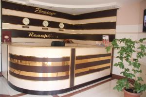 a lobby of a hotel with a reception counter at Flamingo in Aktobe