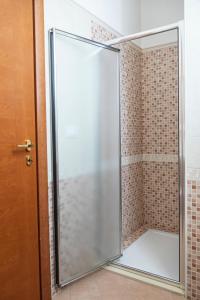 a shower with a glass door in a bathroom at Agriturismo Panacea in Santa Cesarea Terme +39 photos